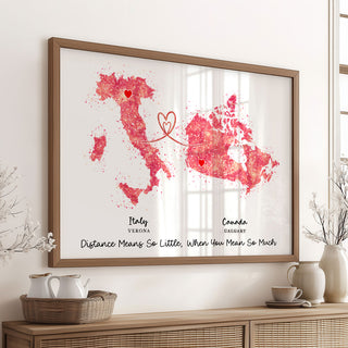 Framed artwork of Italy and Canada with hearts on a wall above a wooden console table.