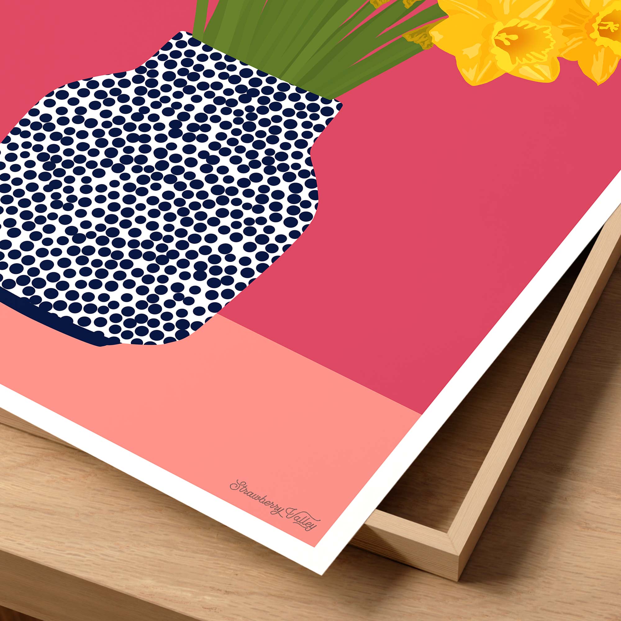 Framed artwork of a pineapple with blue dots on a pink background, featuring yellow flowers.