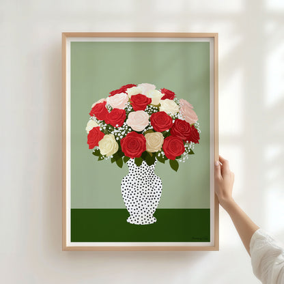 Framed artwork of a polka dot vase with red, pink, and white flowers on a green background.