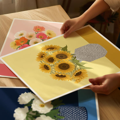 Person holding a sheet of paper with sunflower design on a wooden table